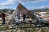 Friends and neighbors work in the ruins of Pastor David Cooper's home the morning after a tornado swept through the area Thursday, Mar. 24, 2011 near Greenback. Cooper's three-story home and 5-car garage, containing classic cars, suffered a direct hit by the storm. Cooper is pastor of New Life Ministries Christian Center on US Highway 411.

