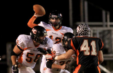 Lenoir City quarterback Jordan Hall, back, throws a pass against Powell on Friday, November 18, 2011 at Powell High School.