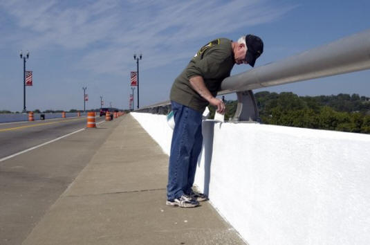 Marvin Stanley of Lenoir City puts a coat of paint on the Veterans Memorial-John Duncan Bridge on Sunday, September 11, 2011 during Loudon Bridge Day. Hundreds of volunteers gathered to paint the bridge in as part of the events honoring victims of September 11, 2001. 
  
 (Saul Young/News Sentinel)
