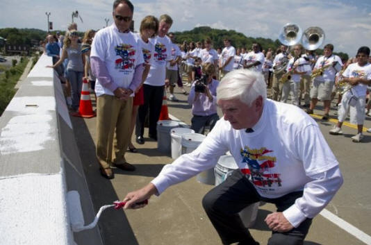 Congressman John Duncan Jr. rolls a coat of paint onto the Veterans Memorial-John Duncan Bridge on Sunday, September 11, 2011 as part of the closing ceremonies of Loudon Bridge Day. 
  
 (Saul Young/News Sentinel)
