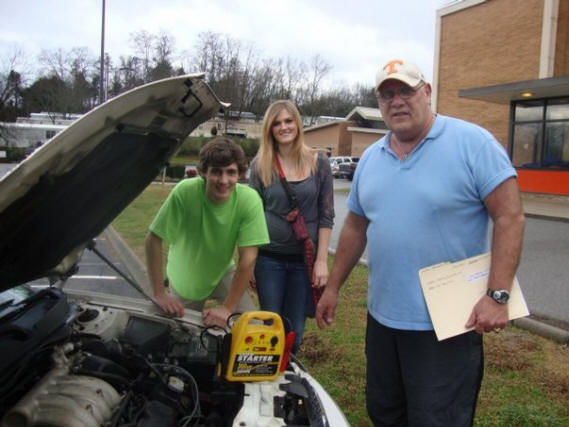 Special to the News Sentinel
Teacher David Moore, right, recently jump started the vehicle of siblings Jordan and Jennifer McKenzie.

