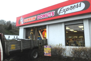 Workers use a flat-bed truck to haul off debris as they clean up after an unidentified female driver slammed her car into the side of the TravelCenters of America gas station.  (ADAM BRIMER/NEWS SENTINEL)
