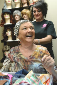 MICHAEL PATRICK/NEWS SENTINEL
Maxine Odomirok visits the wig room at the American Cancer Society on May 9 looking for some scarves and turbans. A friend told me about this so after my treatment today I came over, she said. This is wonderful. Cindy Conner, back, was one of three students from the Tennessee School of Beauty there to assist in her search.
