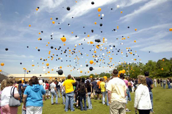 Students, teachers, and family watch as balloons are released during ...